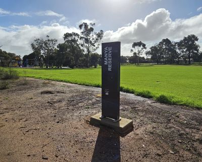 Manya sign and grass area 062026